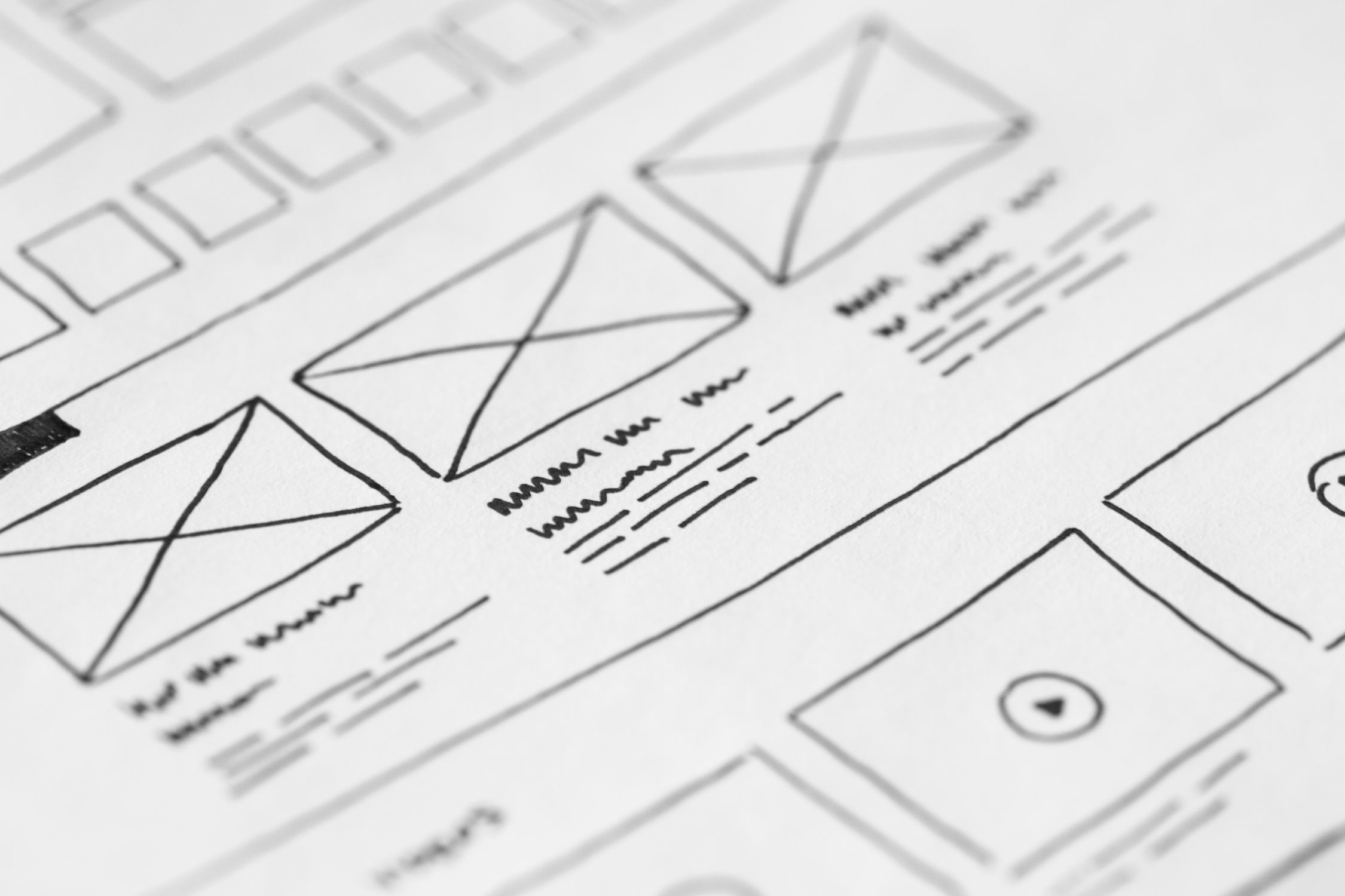 Designer reviewing UI mockups and wireframes on a screen with design tools open