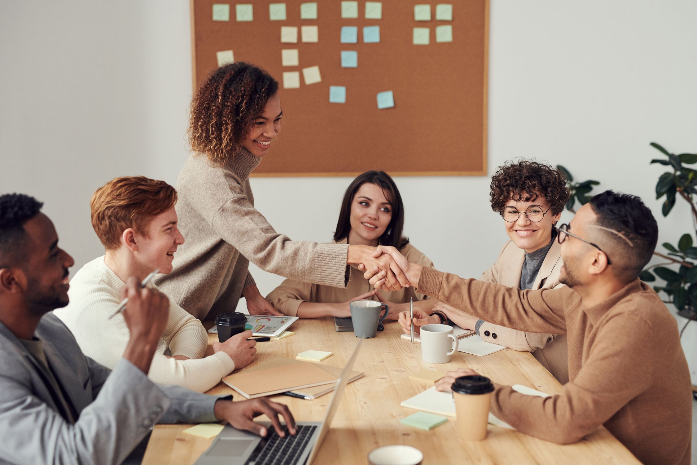 Diverse team of professionals engaged in a collaborative discussion around a conference table