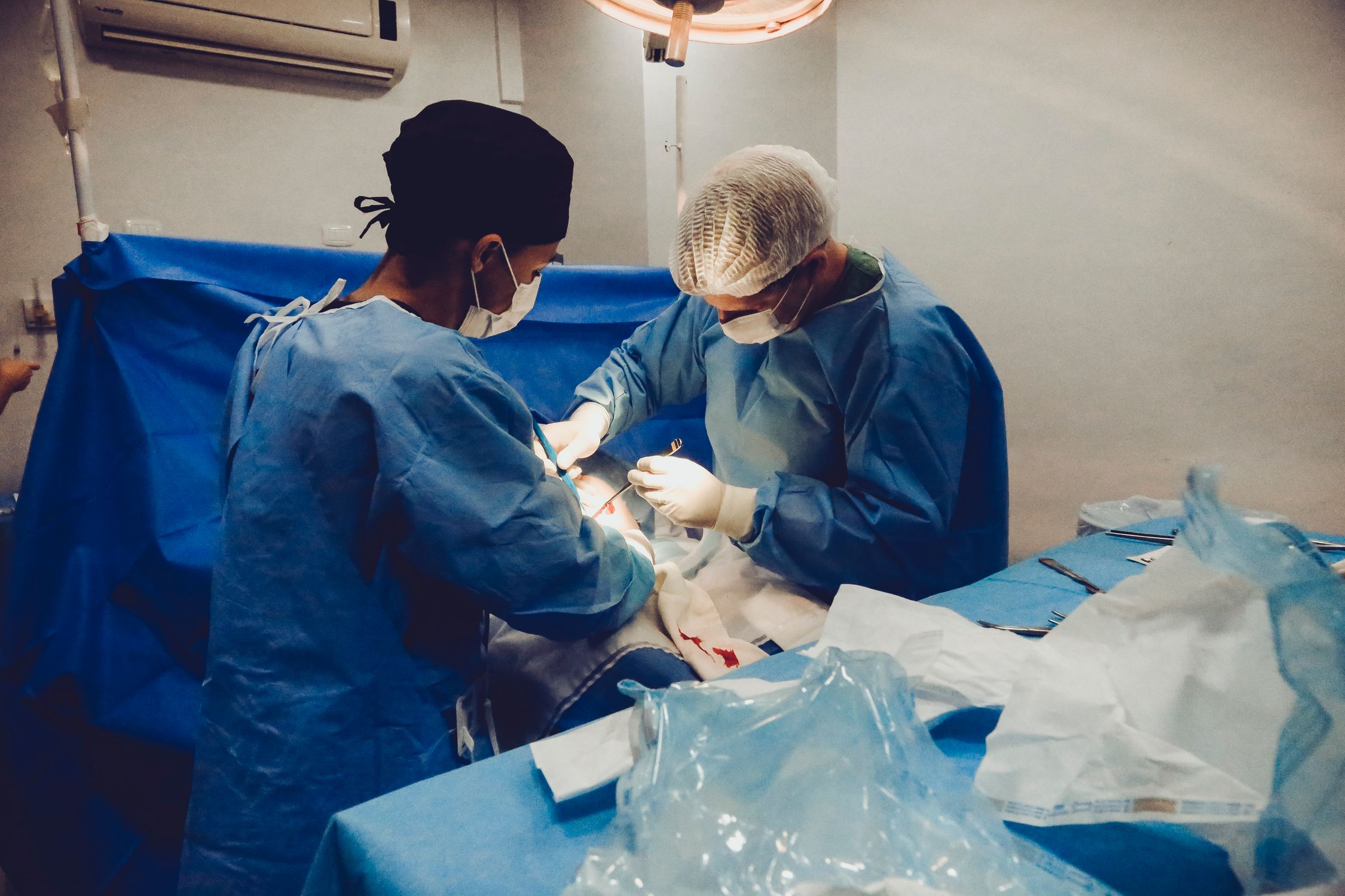 A surgical team working together in an operating room — coordination across systems that must agree on who the patient is