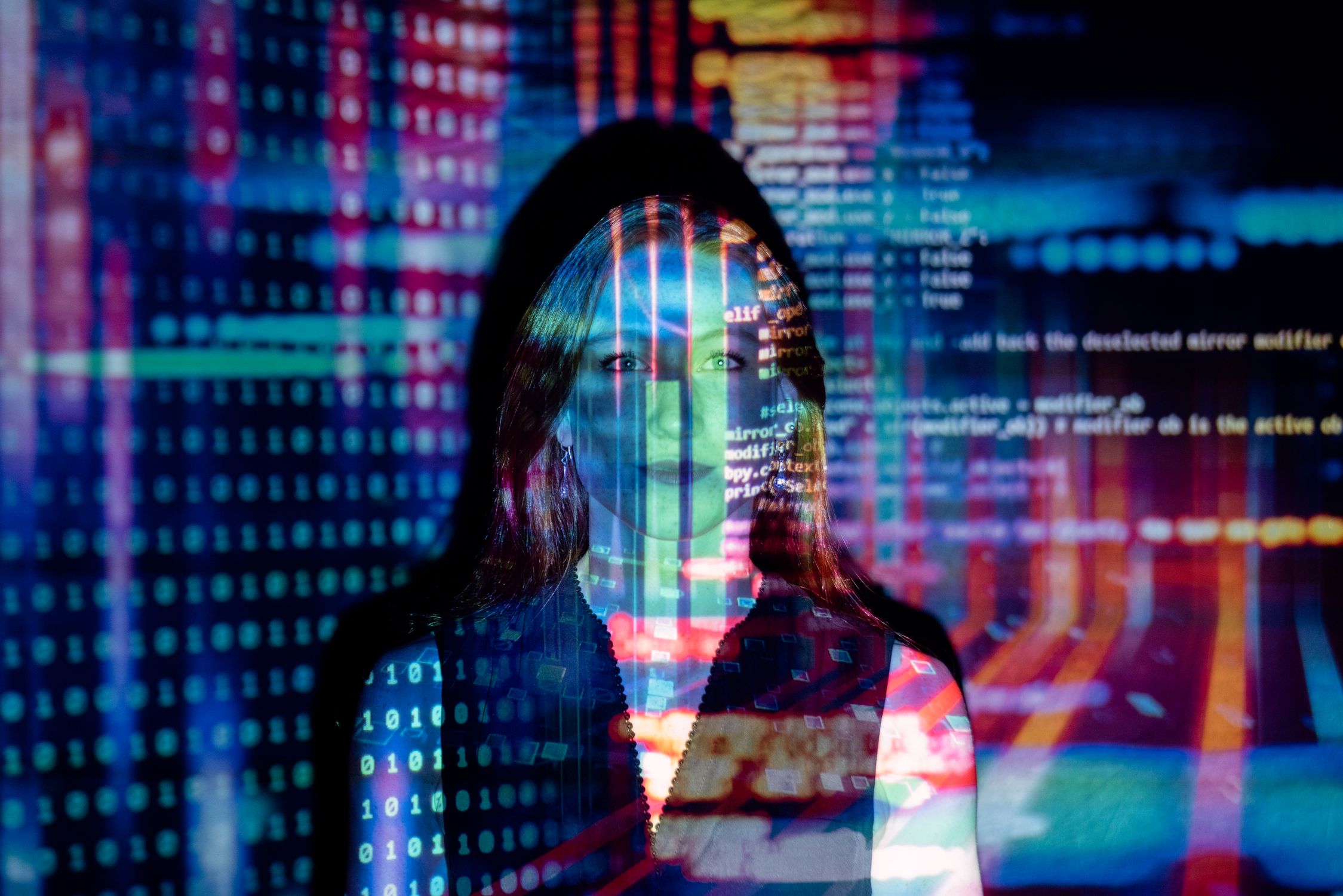 A developer working alongside AI assistance on a laptop — the human still accountable when agents transact with each other